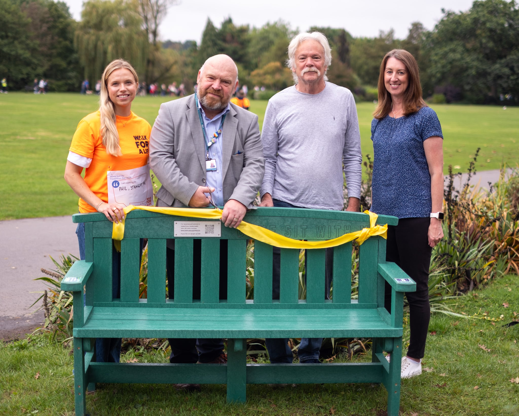 People unveiling support bench